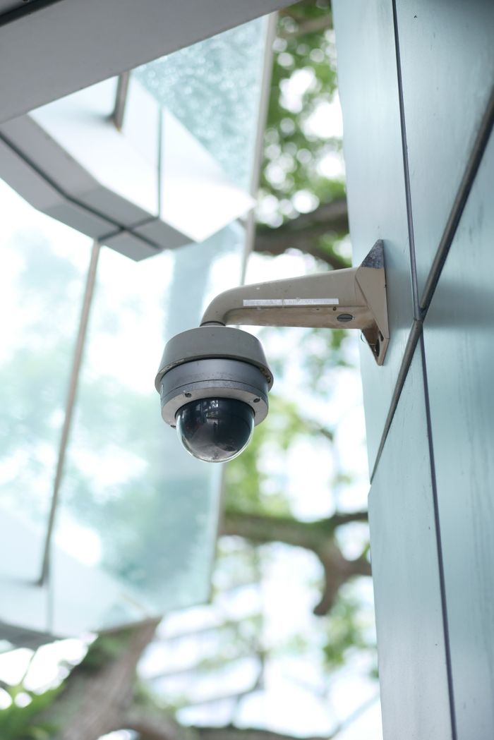 Home A high-tech surveillance camera installed on a modern architecture outdoor wall.